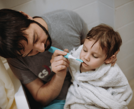 Father brushing his toddler's teeth, brushing every age.